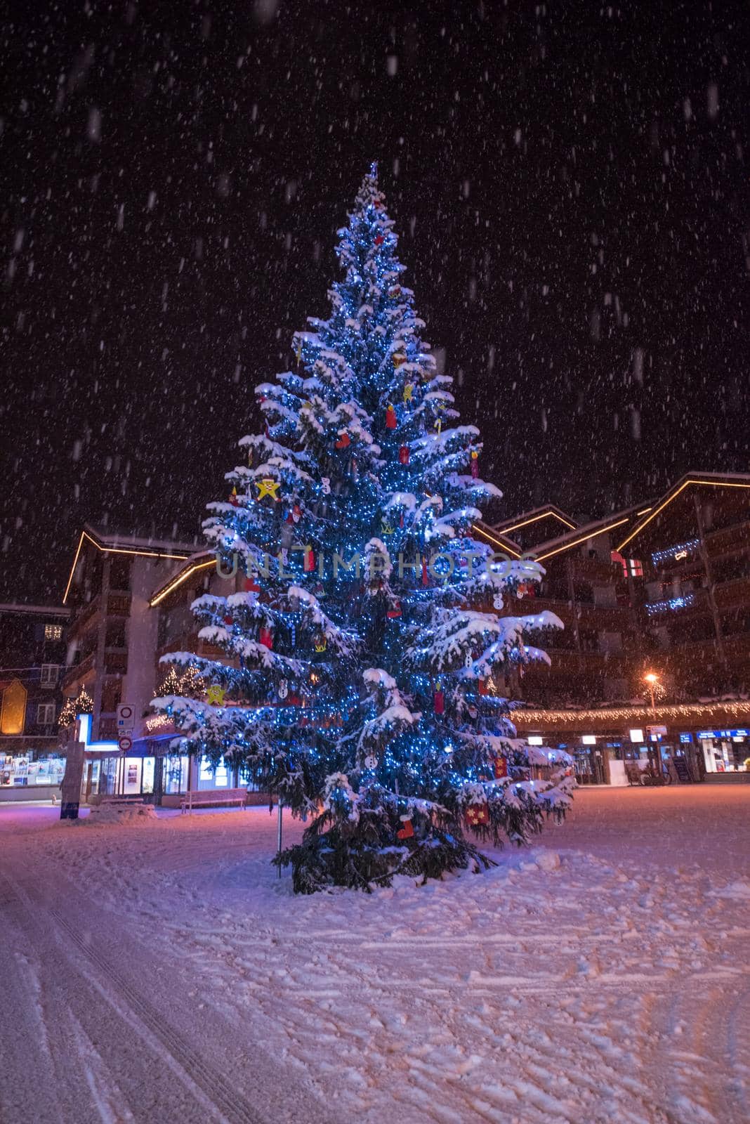 a view on snowy streets of the Alpine mountain village in the cold winter night