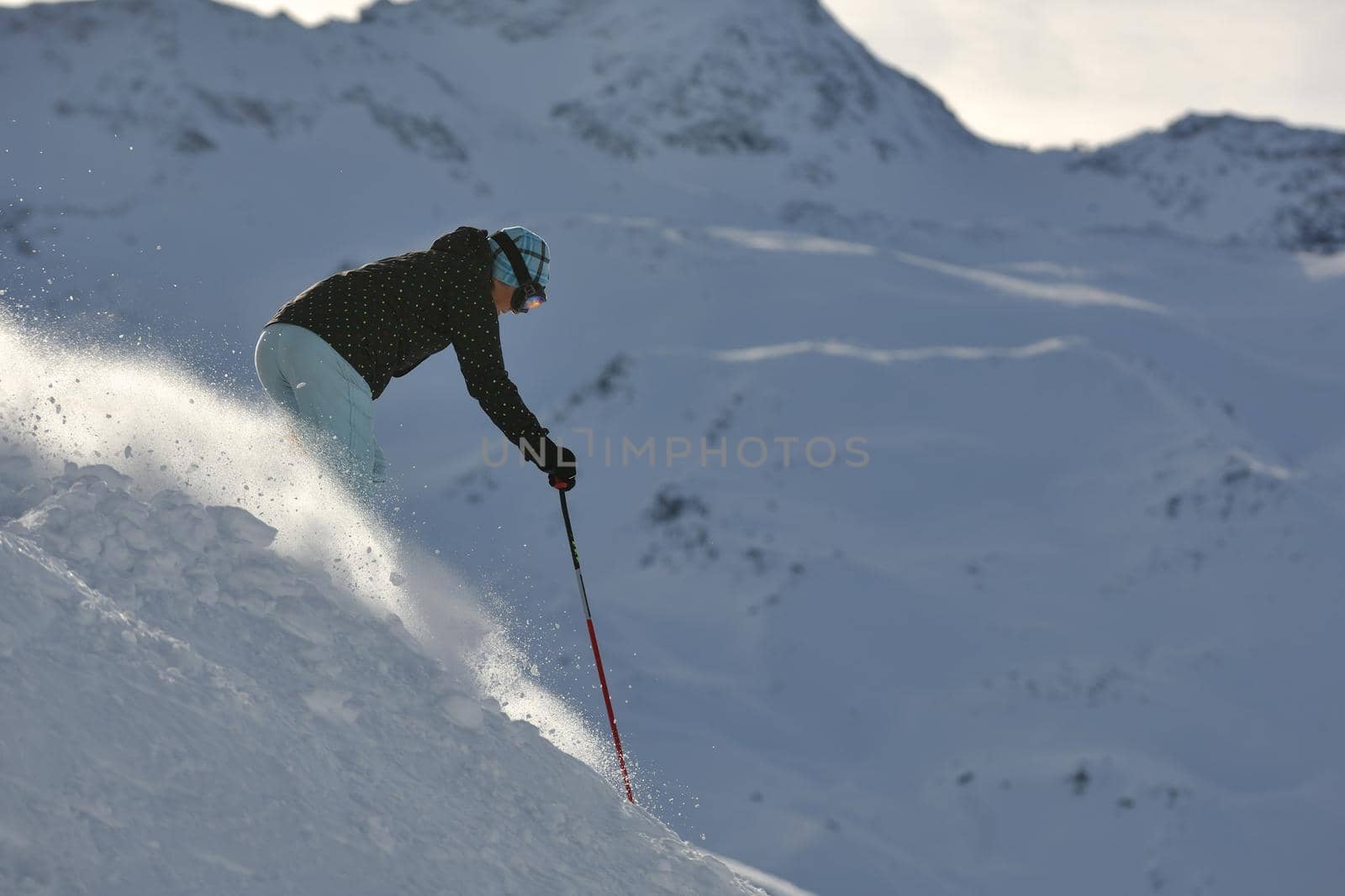woman skiing on fresh snow at winter season  by dotshock