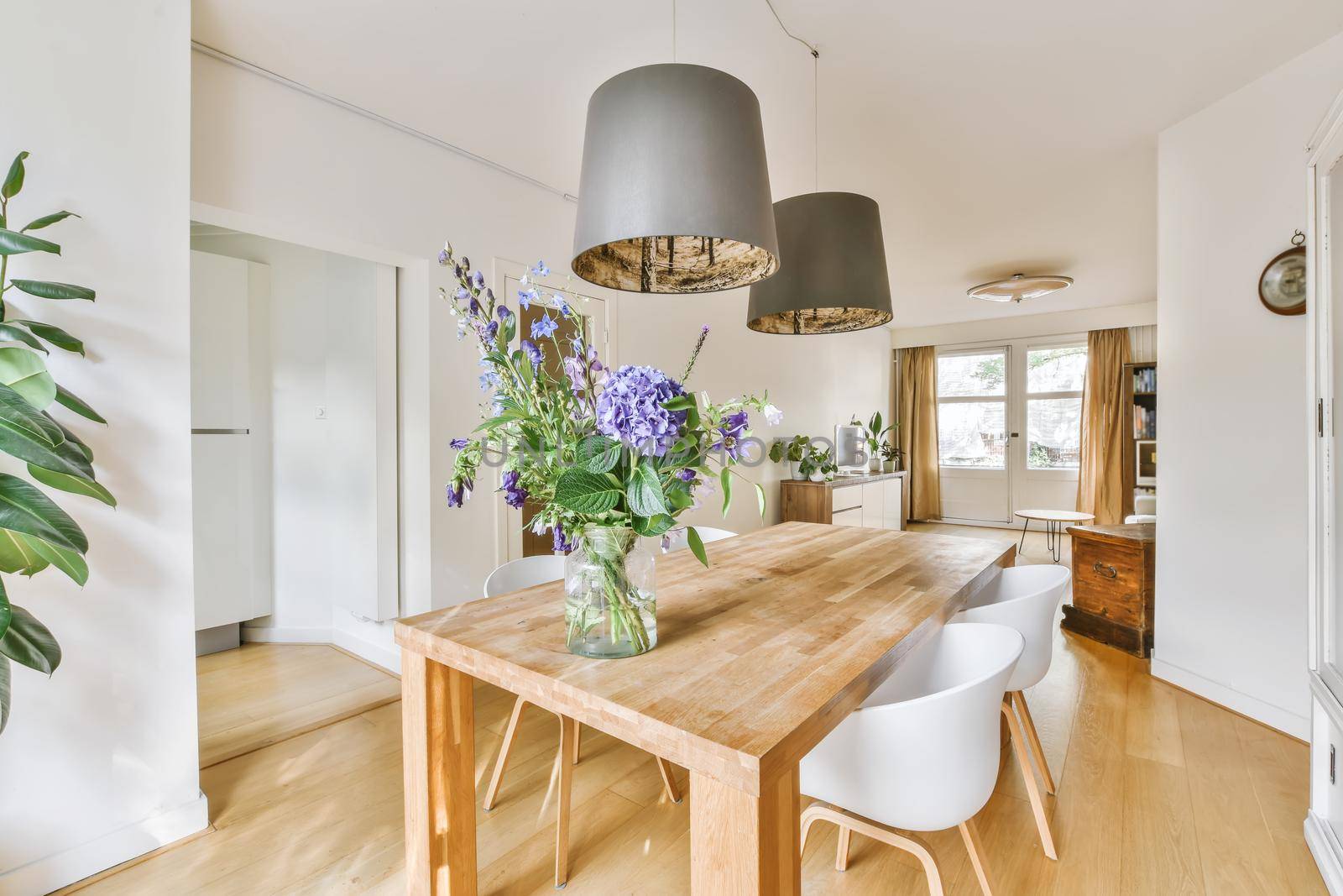 Stylish cozy light dining room with comfortable chairs