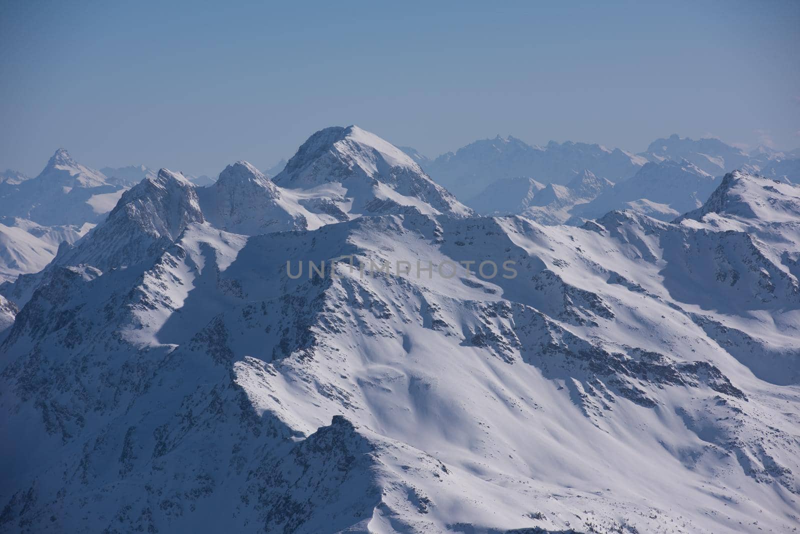 mountain landscape at winter with fresh snow on beautiful sunny day at french alps