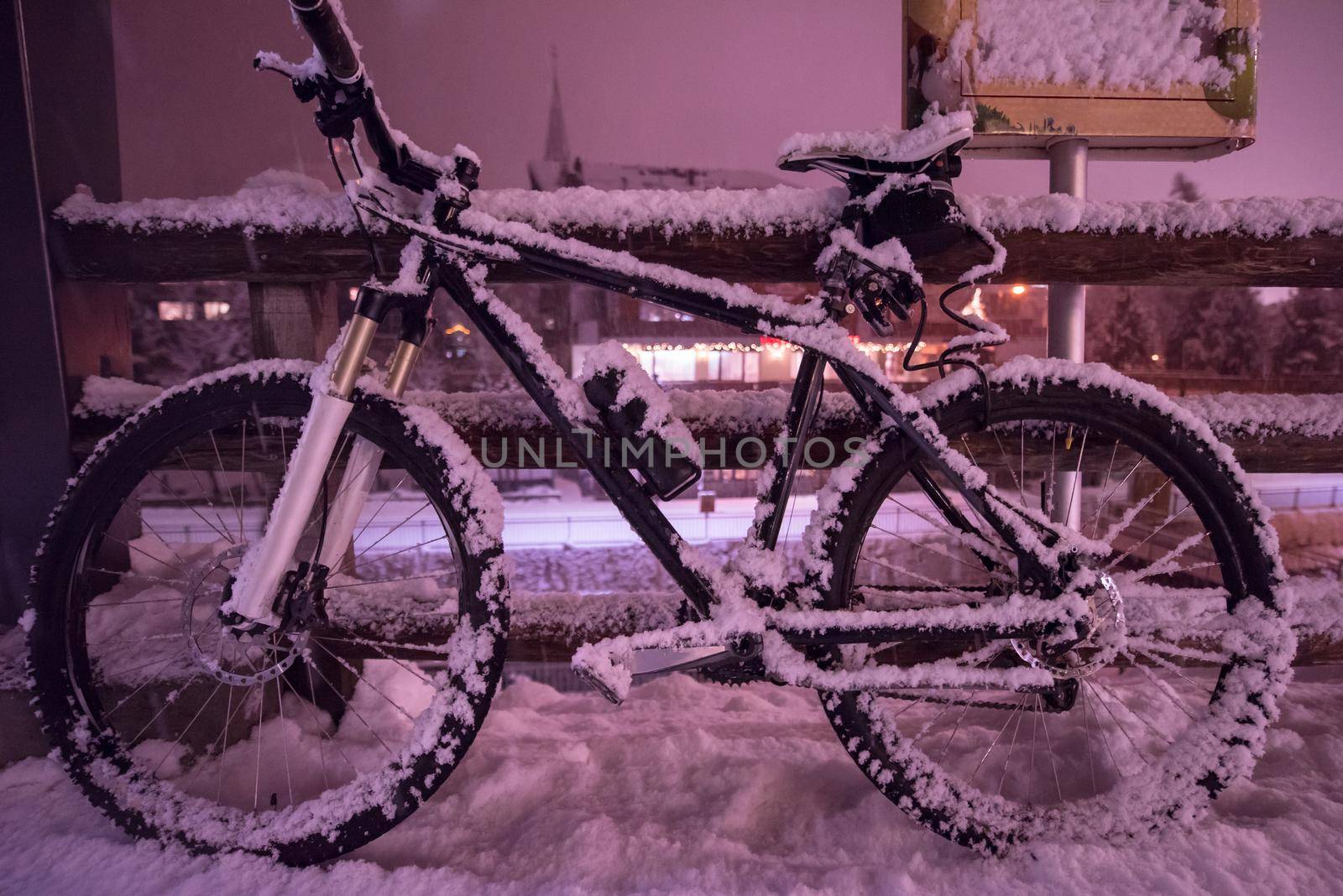 end of biking season.parked bicycle covered by snow from a heavy snowstorm.Winter cycling