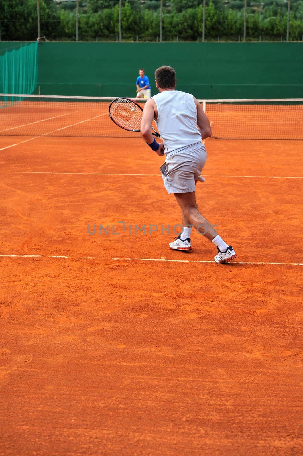 One man play tennis outdoors by dotshock