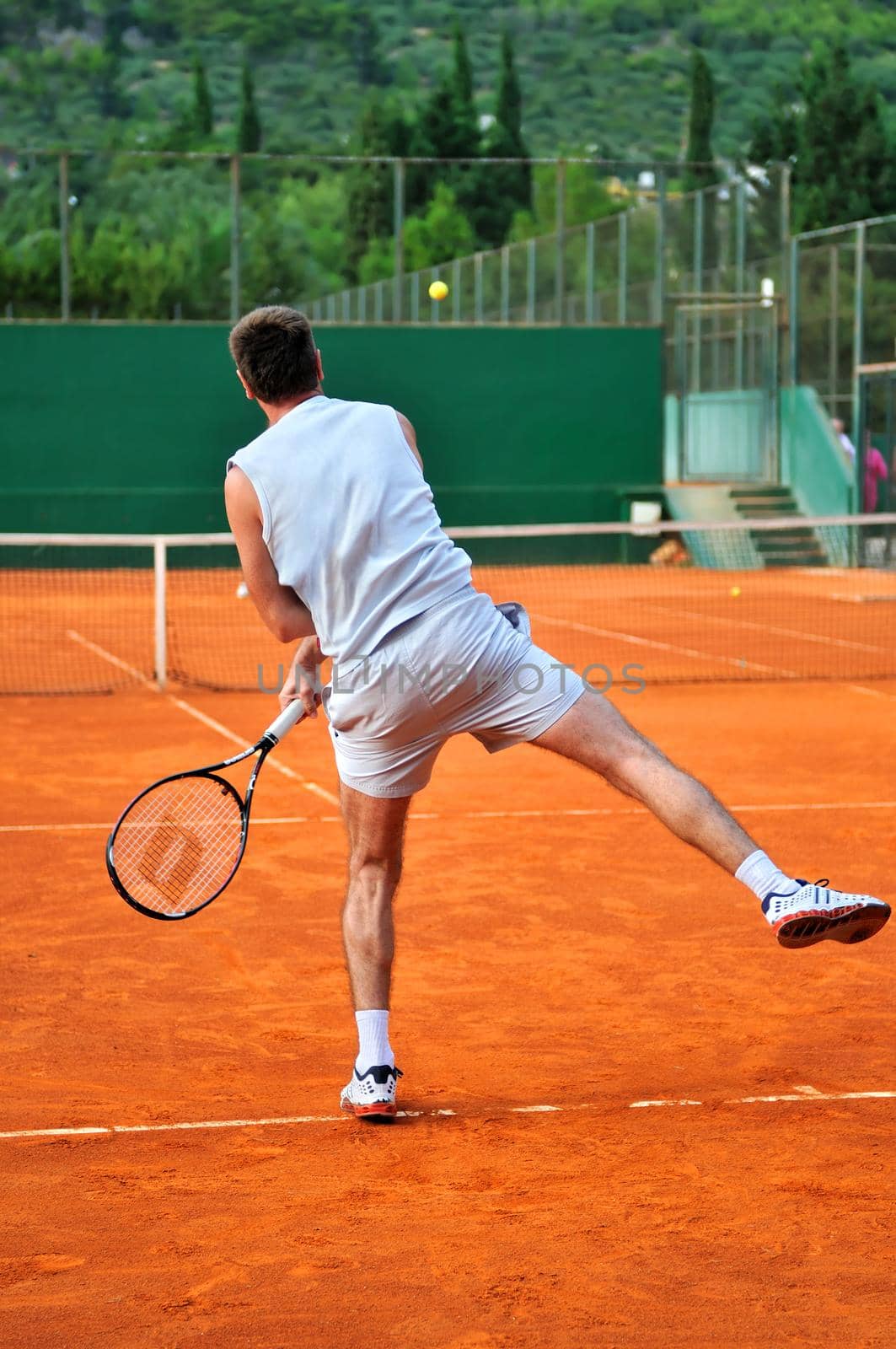 One man play tennis on outdoor court