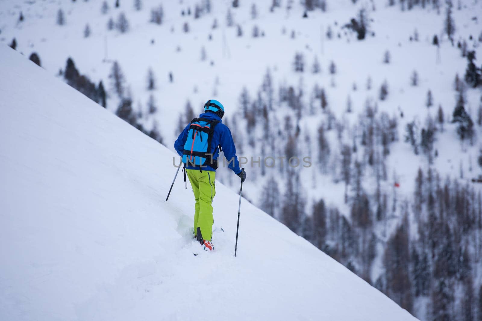 freeride skier skiing downhill by dotshock