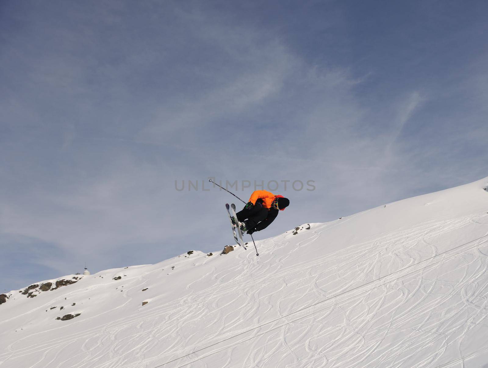 extreme freestyle ski jump with young man at mountain in snow park at winter season