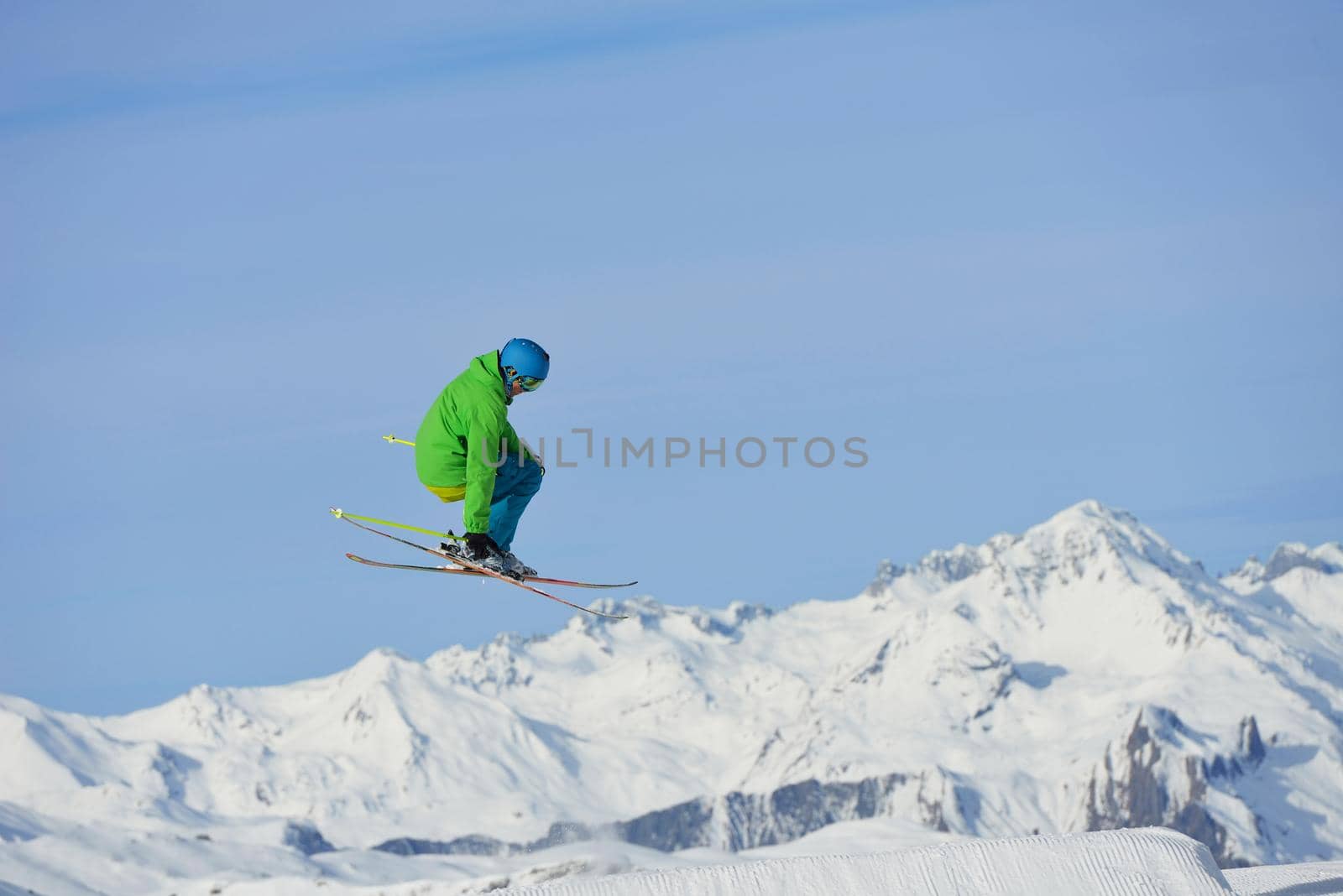 jumping skier at mountain winter snow fresh suny day