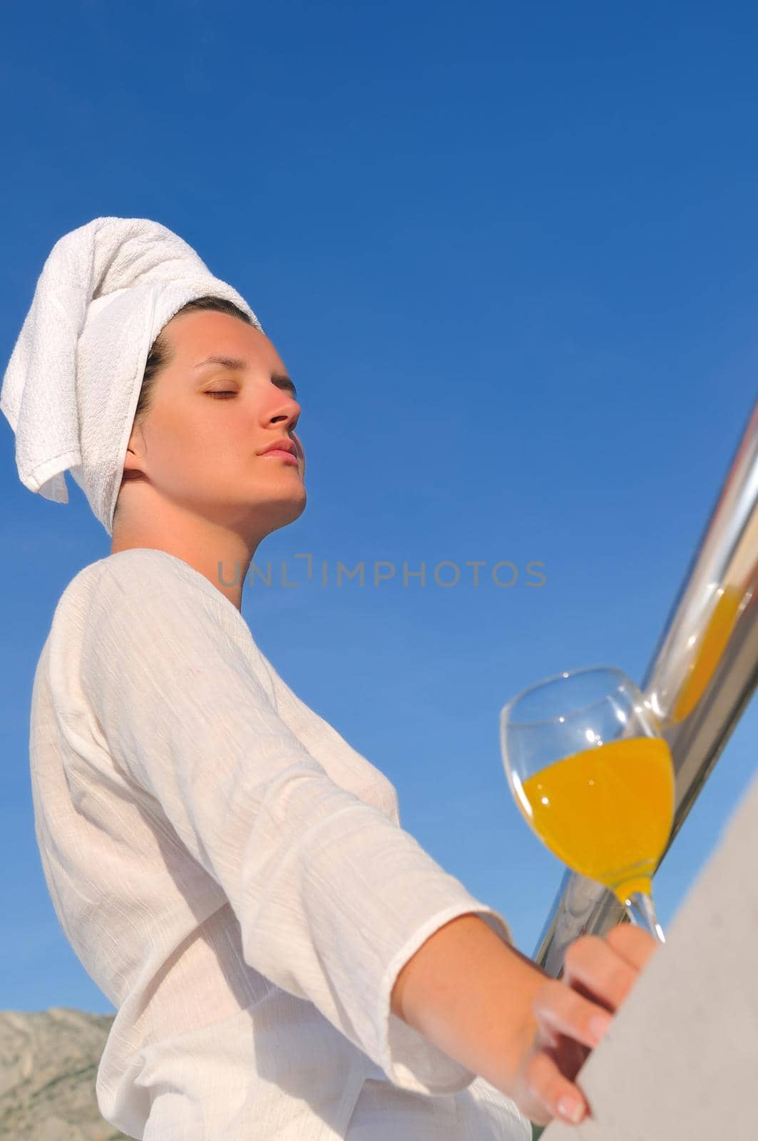 young woman enjoy sum and juice at summer location 