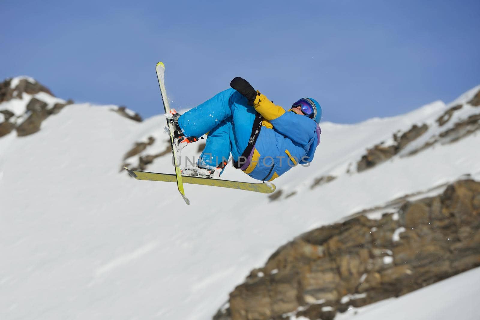 jumping skier at mountain winter snow fresh suny day