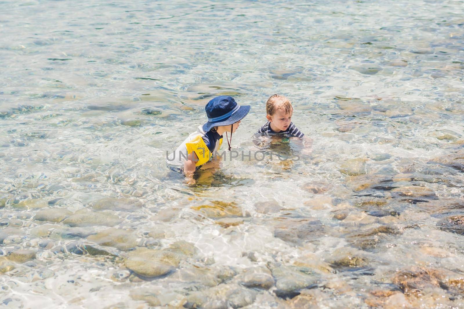 Two boys swimming in the tropical sea