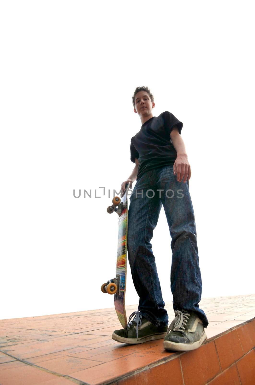 Boy practicing skate in a skate park - isolated