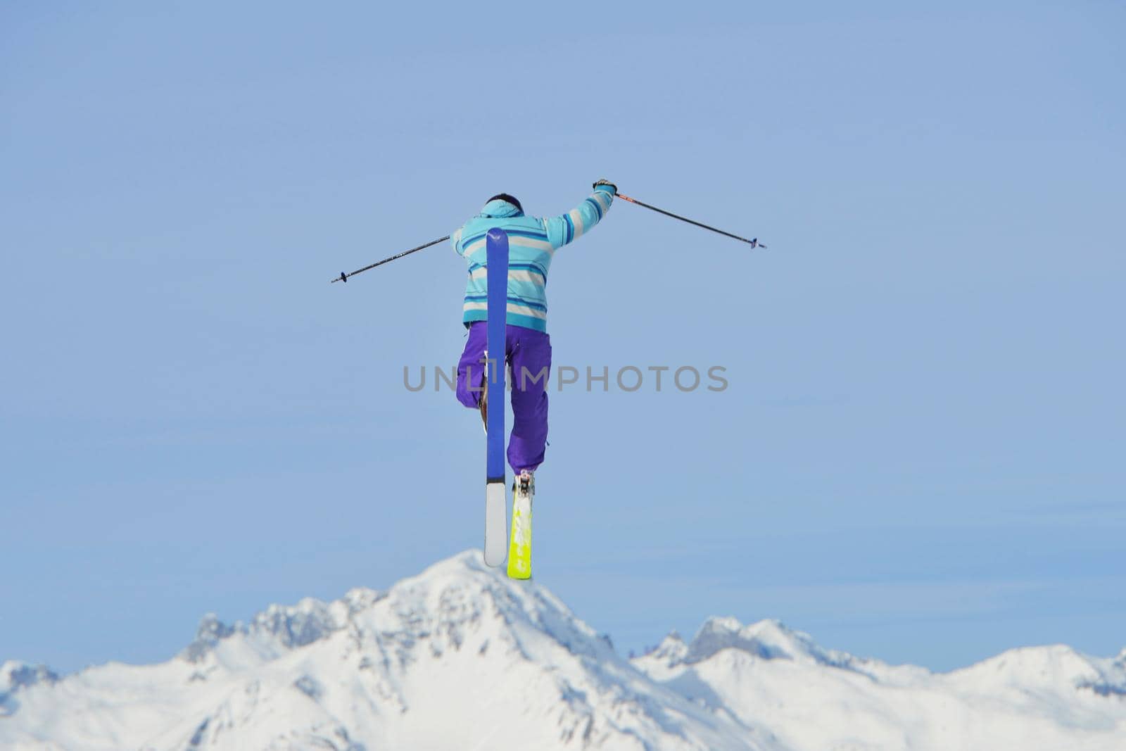 jumping skier at mountain winter snow fresh suny day