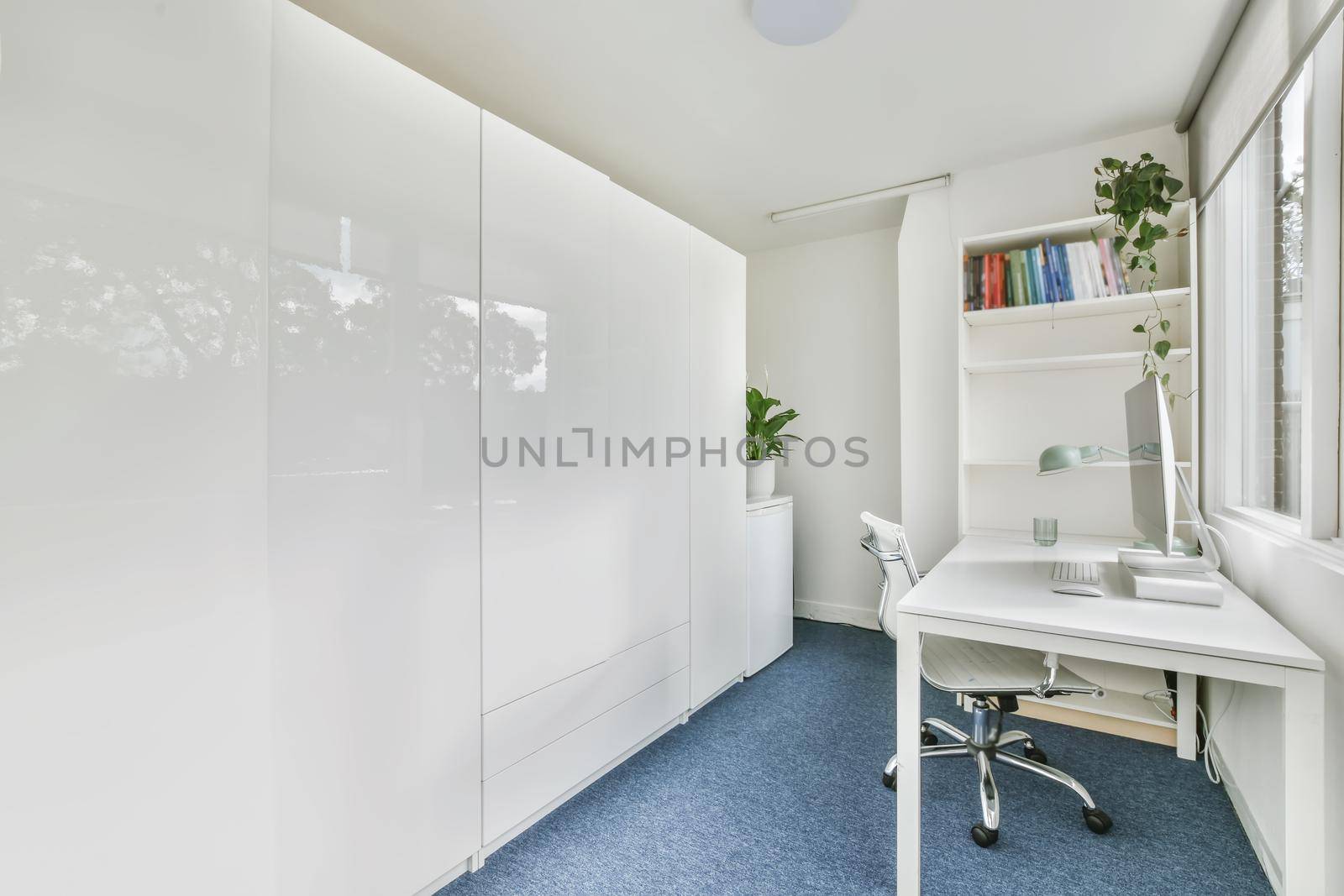 Bright work room with white long work table