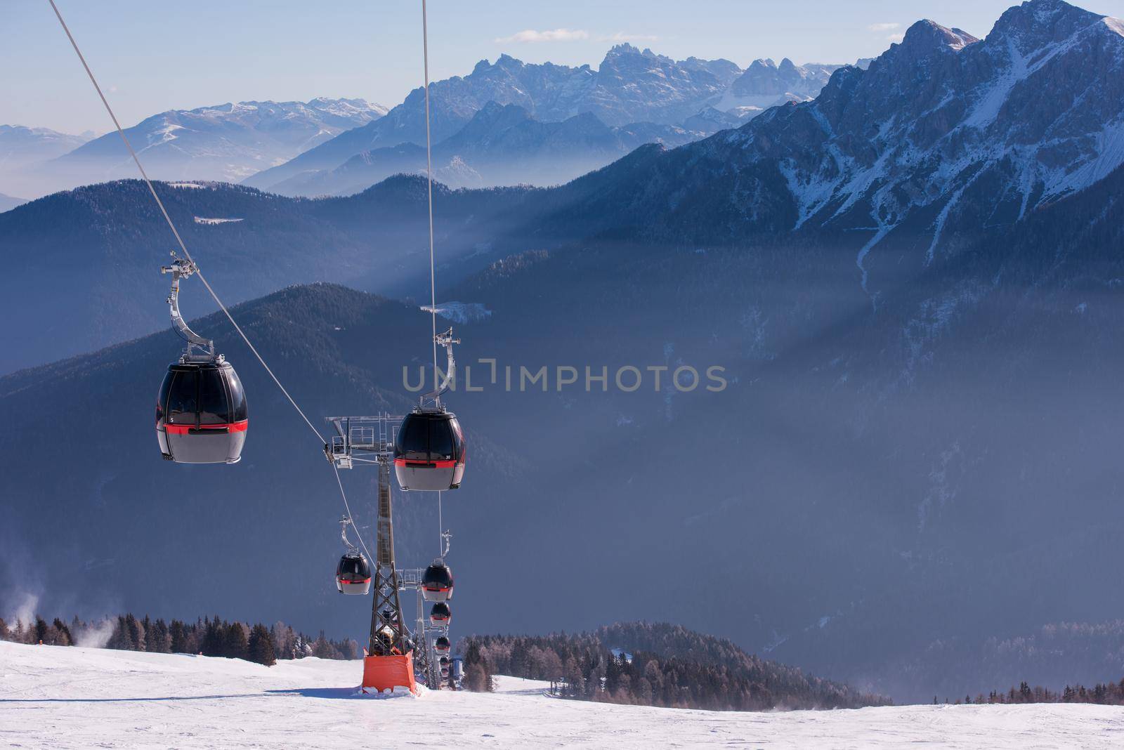 modern gondola lift at ski resort on sunny winter day