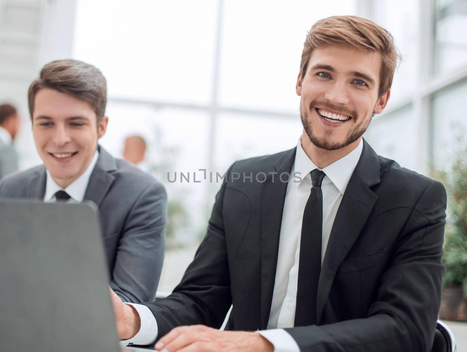 close up. two business men sitting at an office Desk. people and technology