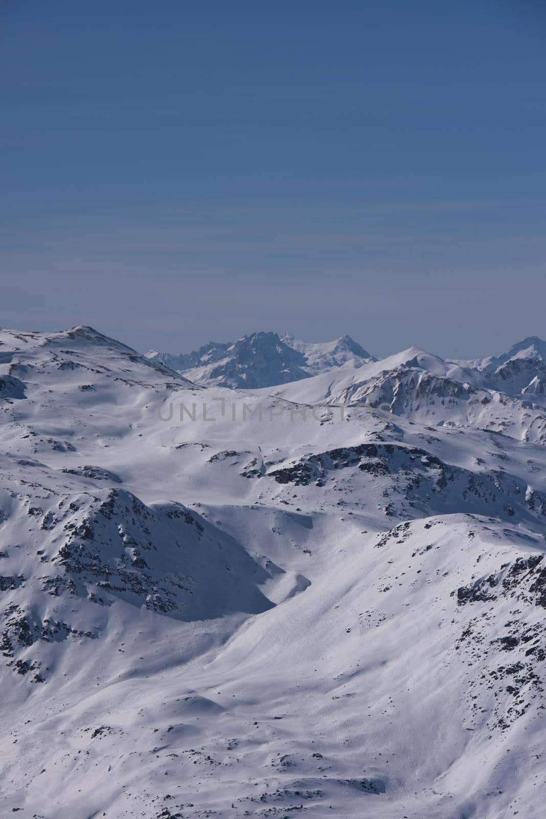 mountain landscape at winter with fresh snow on beautiful sunny day at french alps