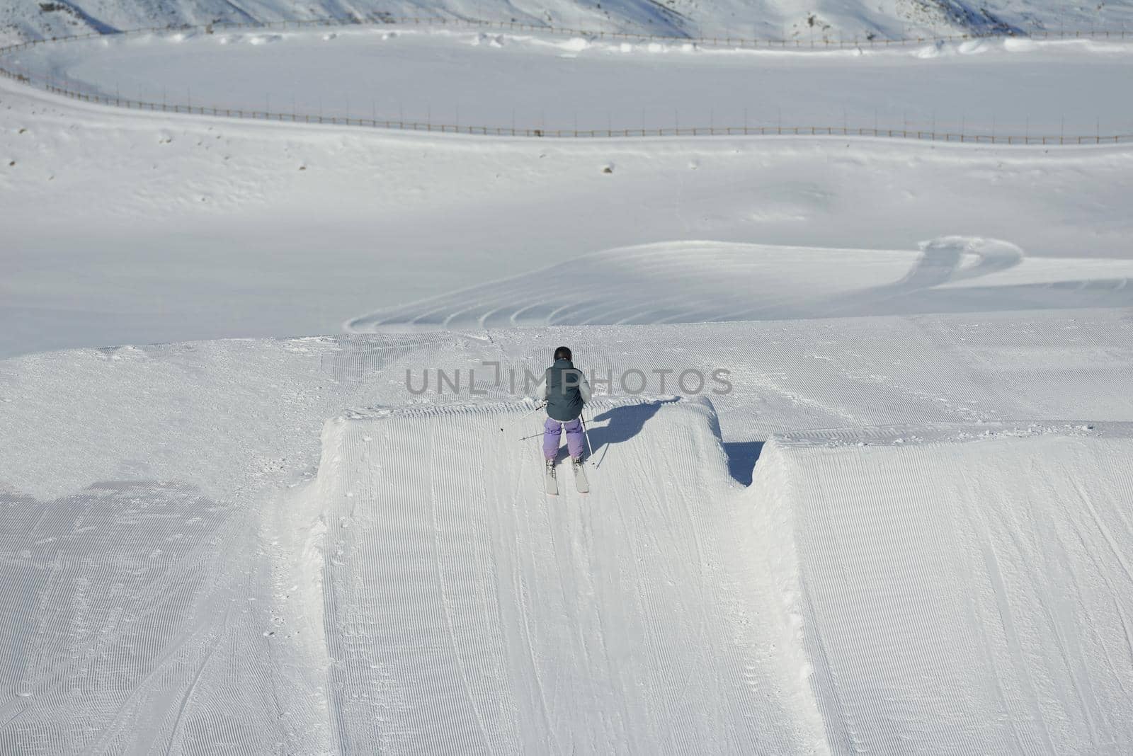 jumping skier at mountain winter snow fresh suny day