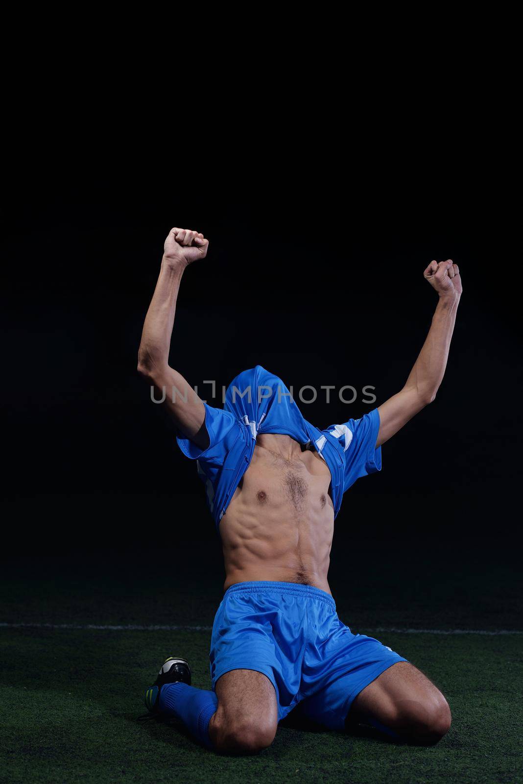 soccer player doing kick with ball on football stadium  field  isolated on black background