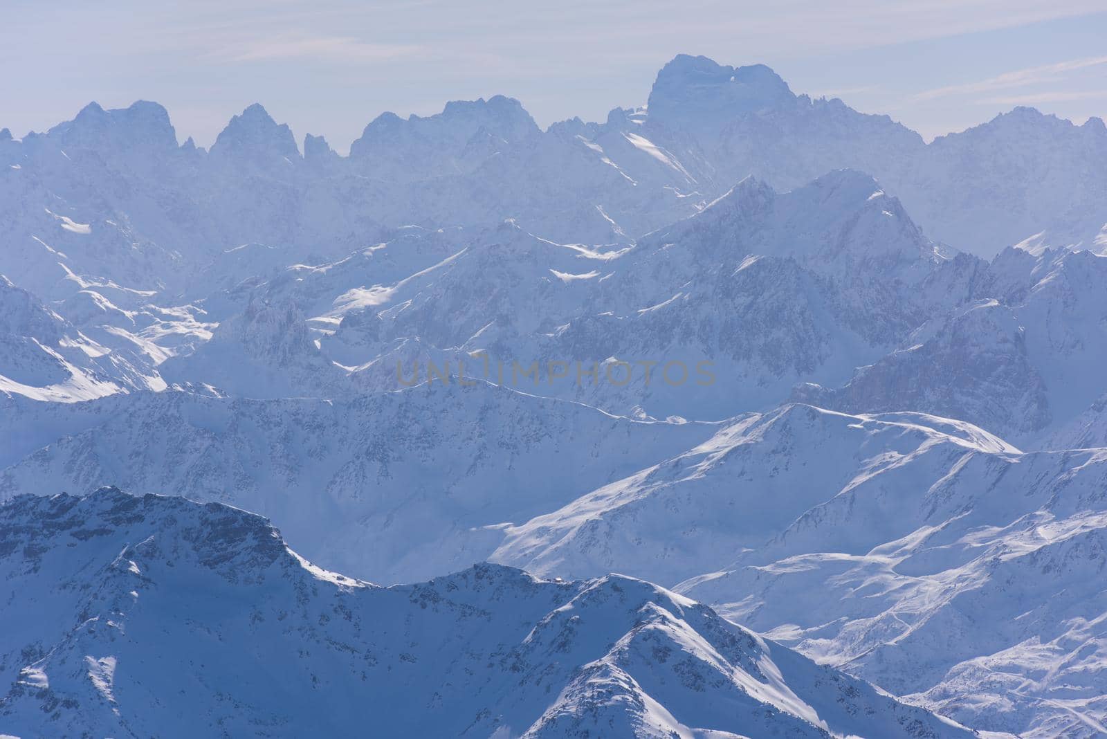 mountain landscape at winter with fresh snow on beautiful sunny day at french alps