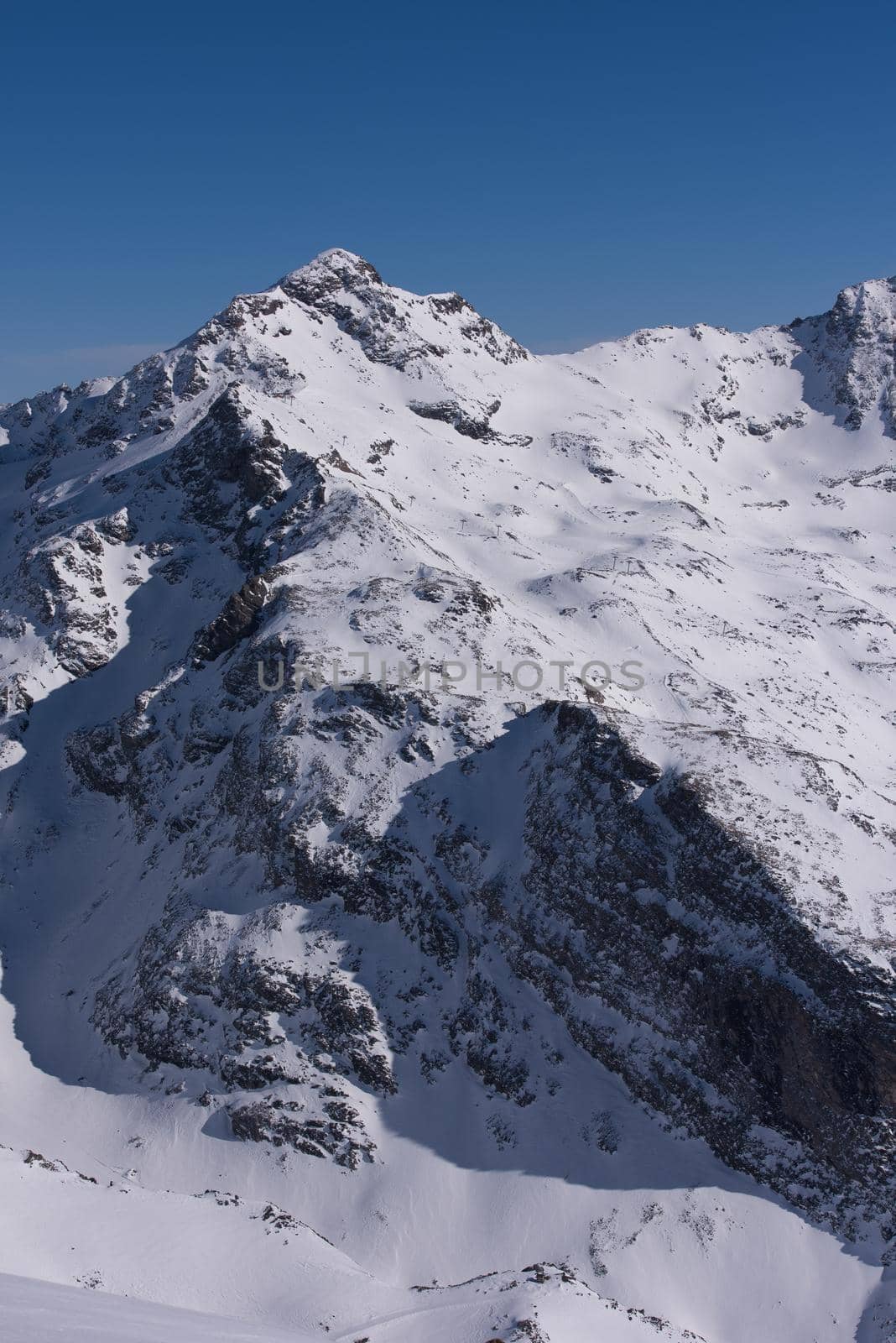 mountain landscape at winter with fresh snow on beautiful sunny day at french alps