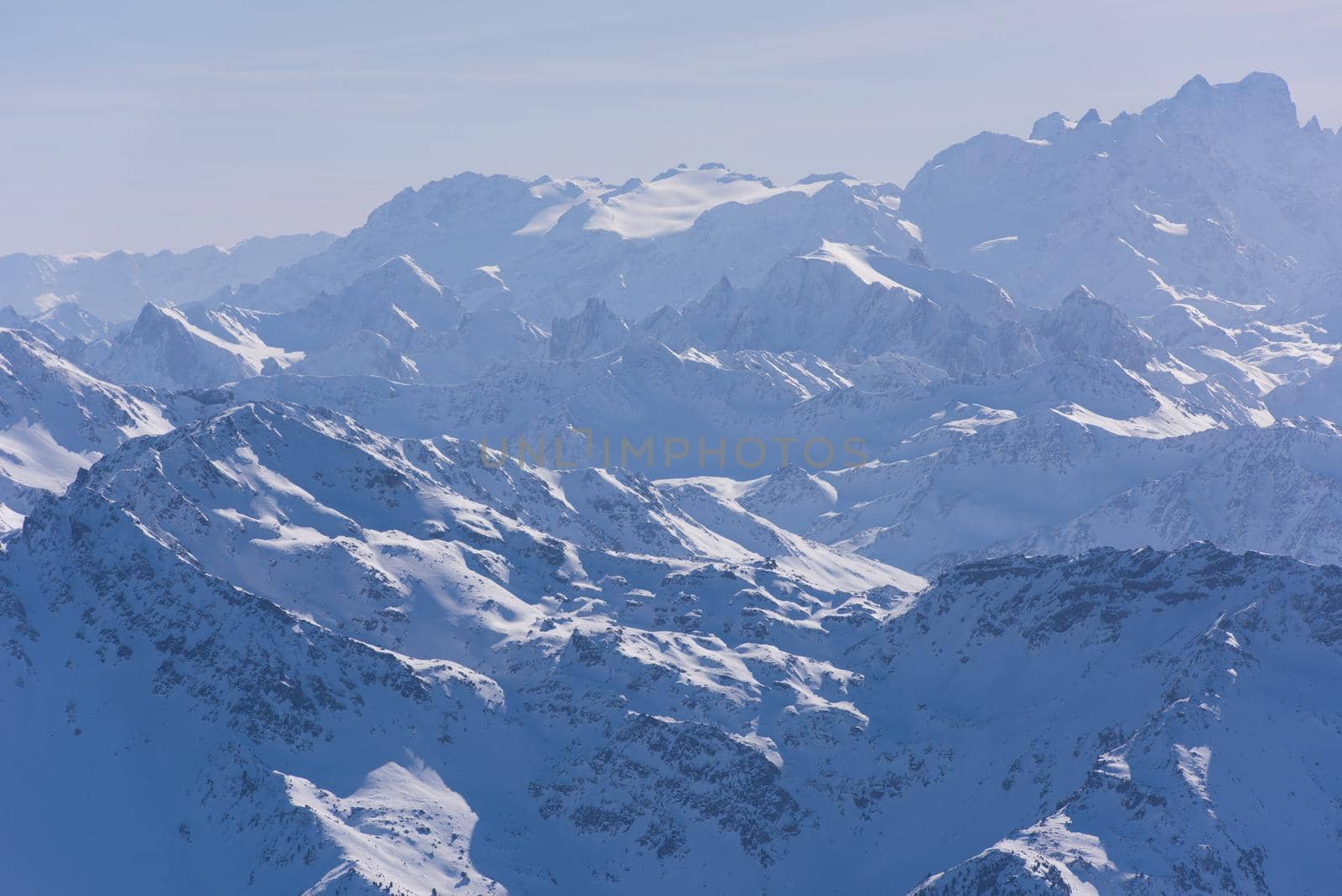 mountain landscape at winter with fresh snow on beautiful sunny day at french alps