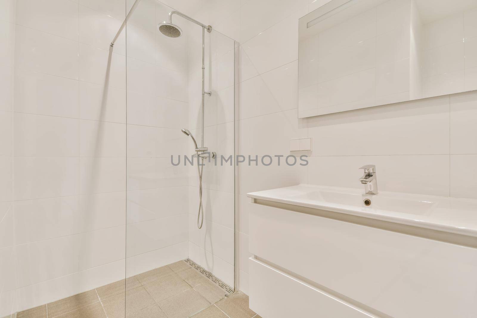 Bathroom interior with hanging chest of drawers and shower cubicle with glass partition