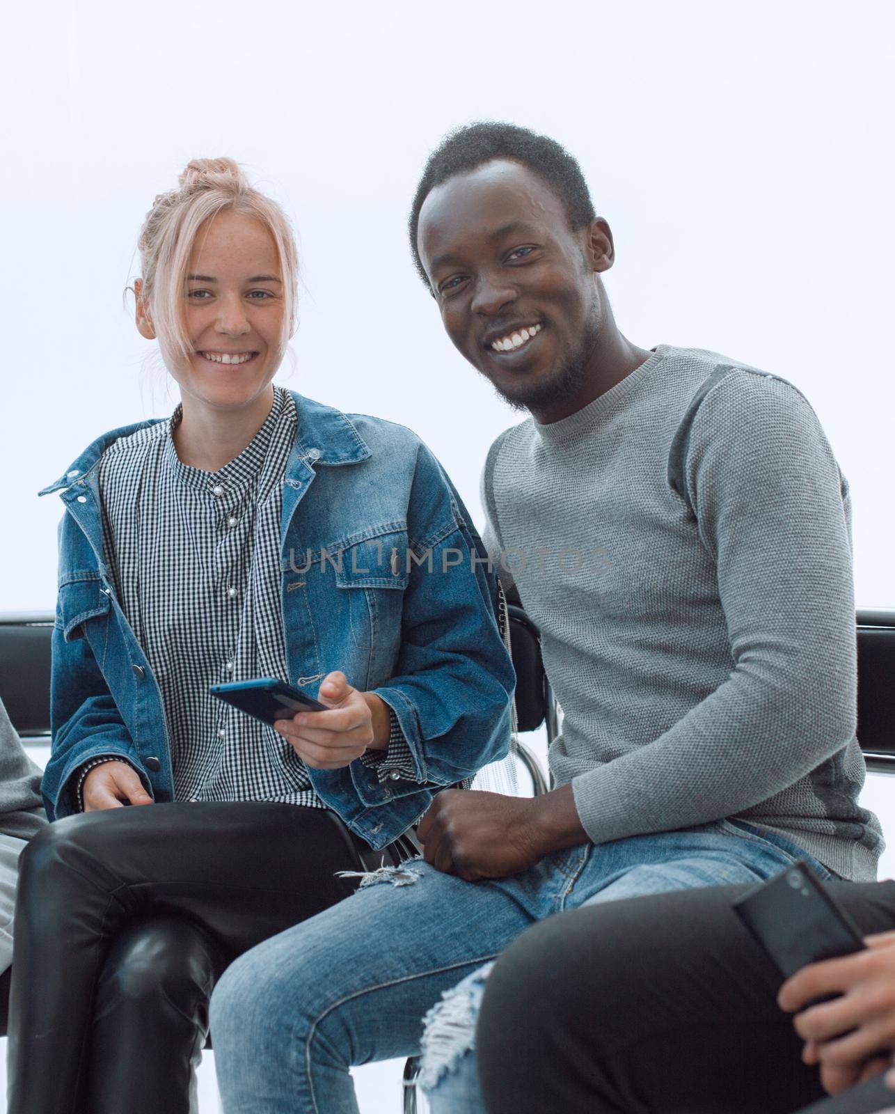 close up. young people reading information on their smartphones . people and technology