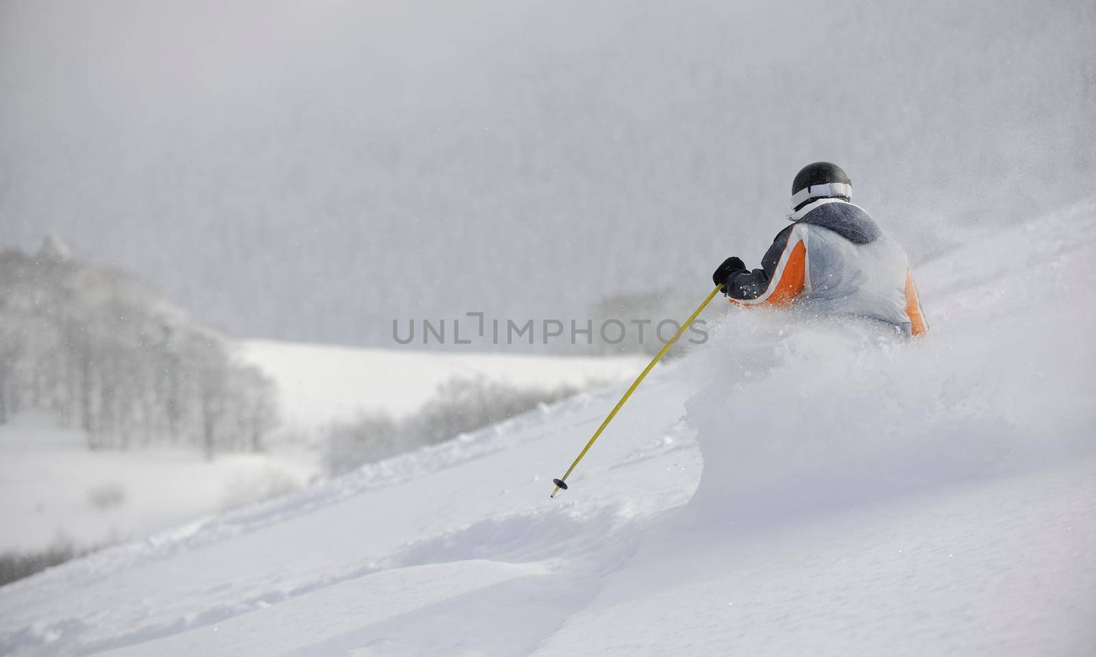 man ski free ride downhill at winter season on beautiful sunny day and powder snow