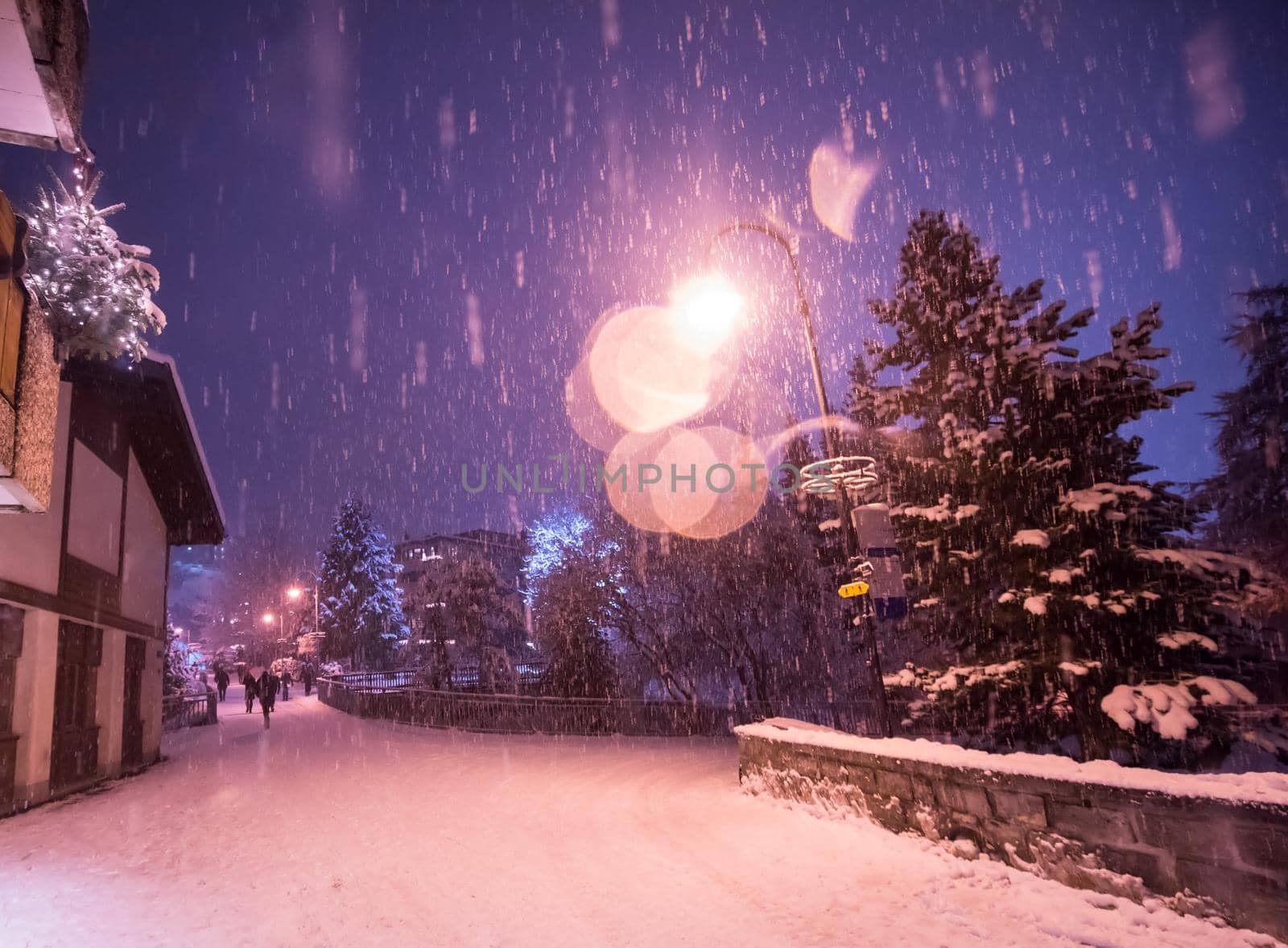 a view on snowy streets of the Alpine mountain village in the cold winter night