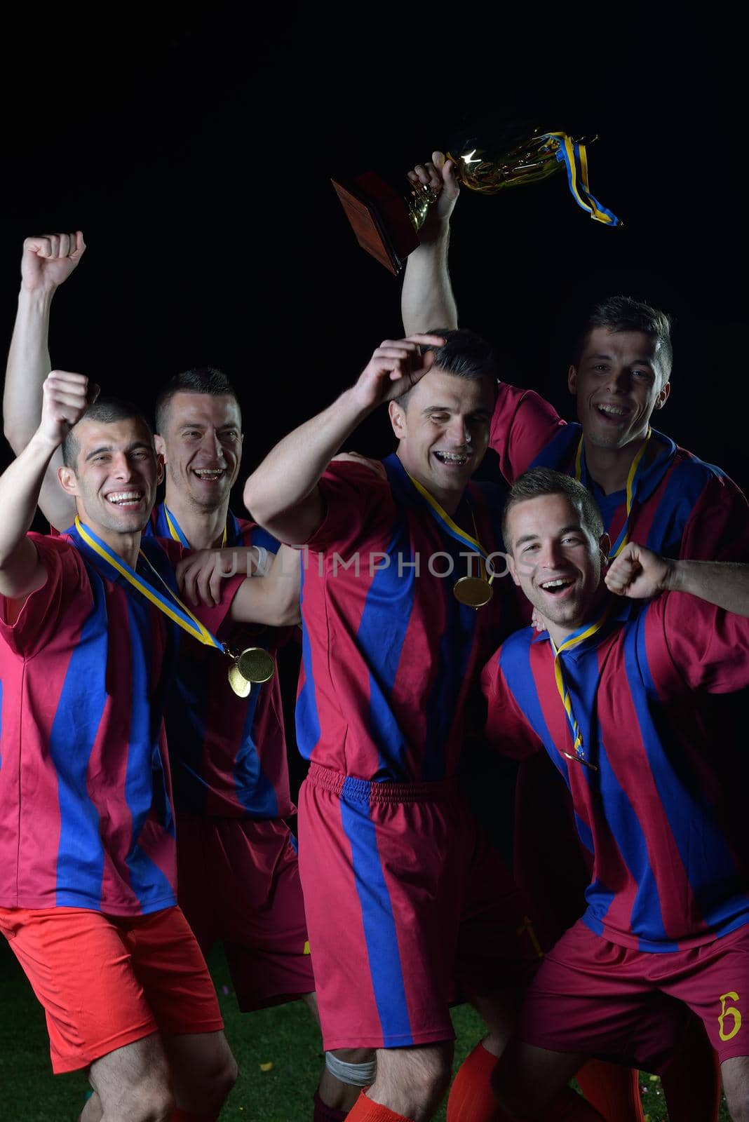 soccer players team group celebrating the victory and become champion of game while holding win coup