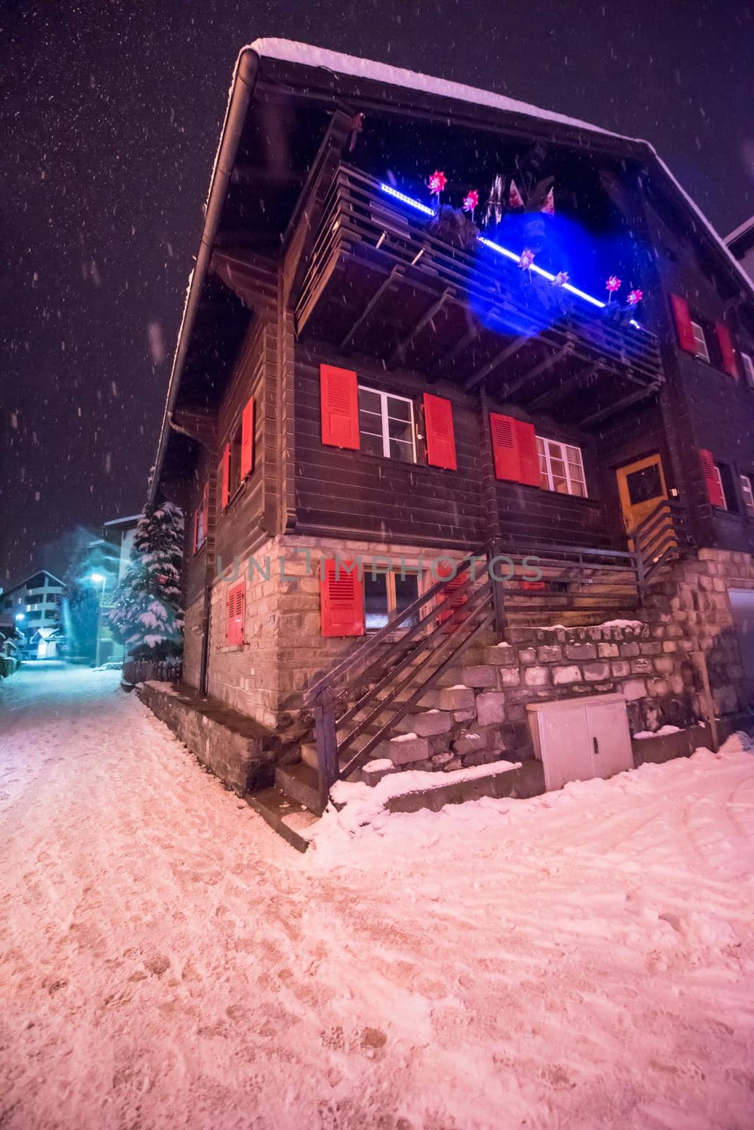 a view on snowy streets of the Alpine mountain village in the cold winter night