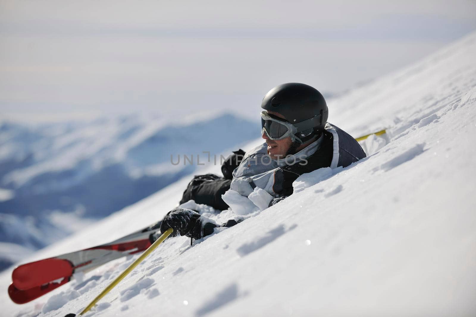 young skier relaxing at beautiful sunny winter day by dotshock