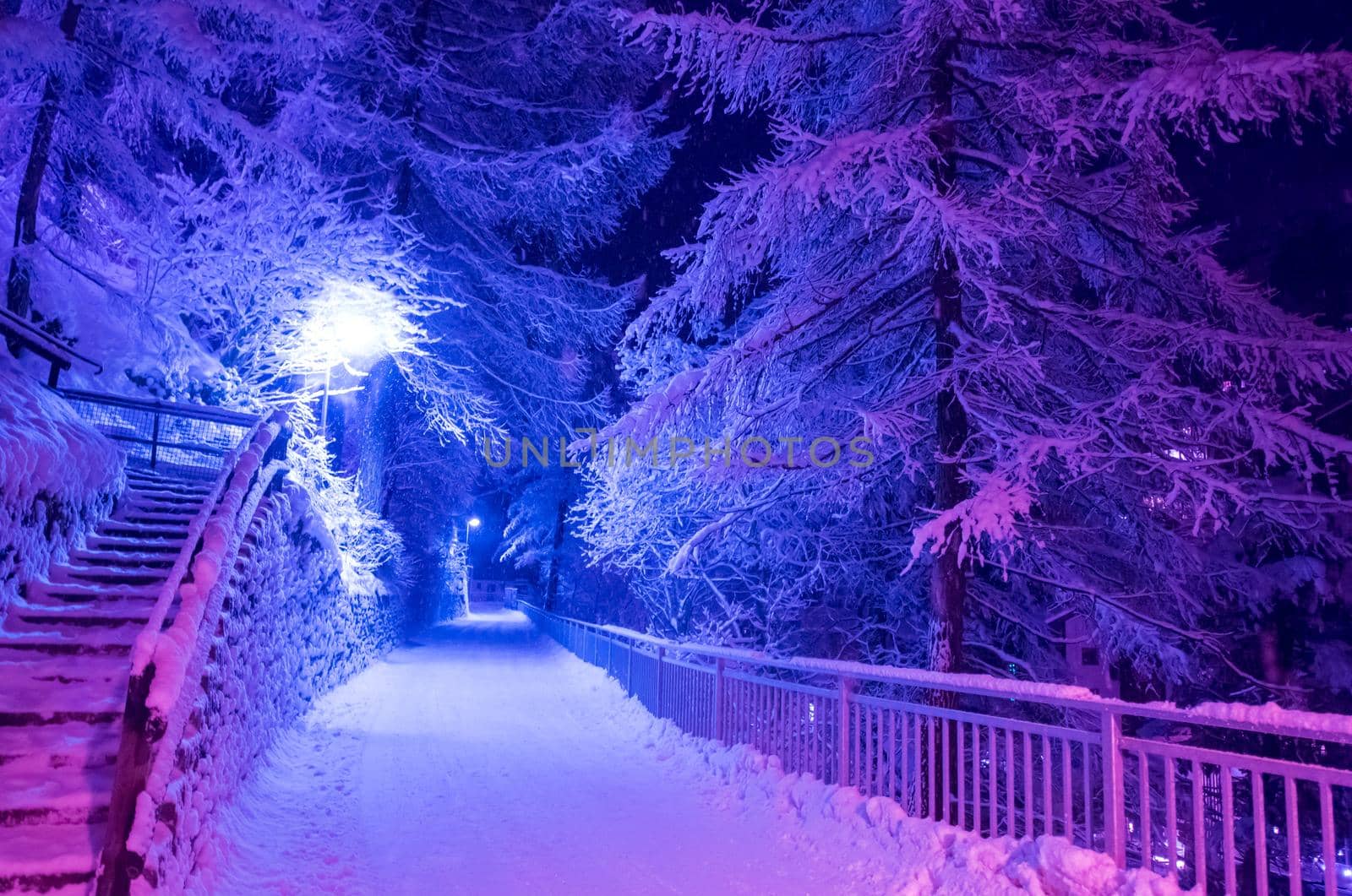 a view on snowy streets of the Alpine mountain village in the cold winter night