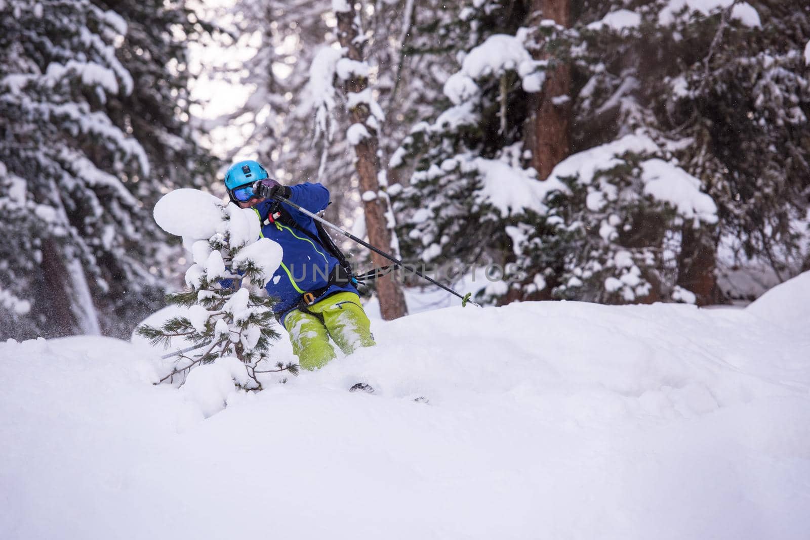 freeride skier skiing downhill by dotshock