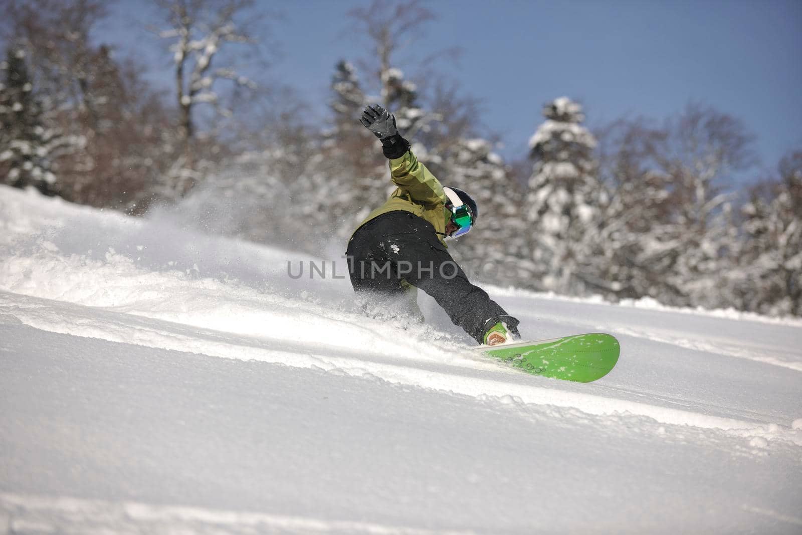 snowboarder woman enjoy freeride on fresh powder snow by dotshock