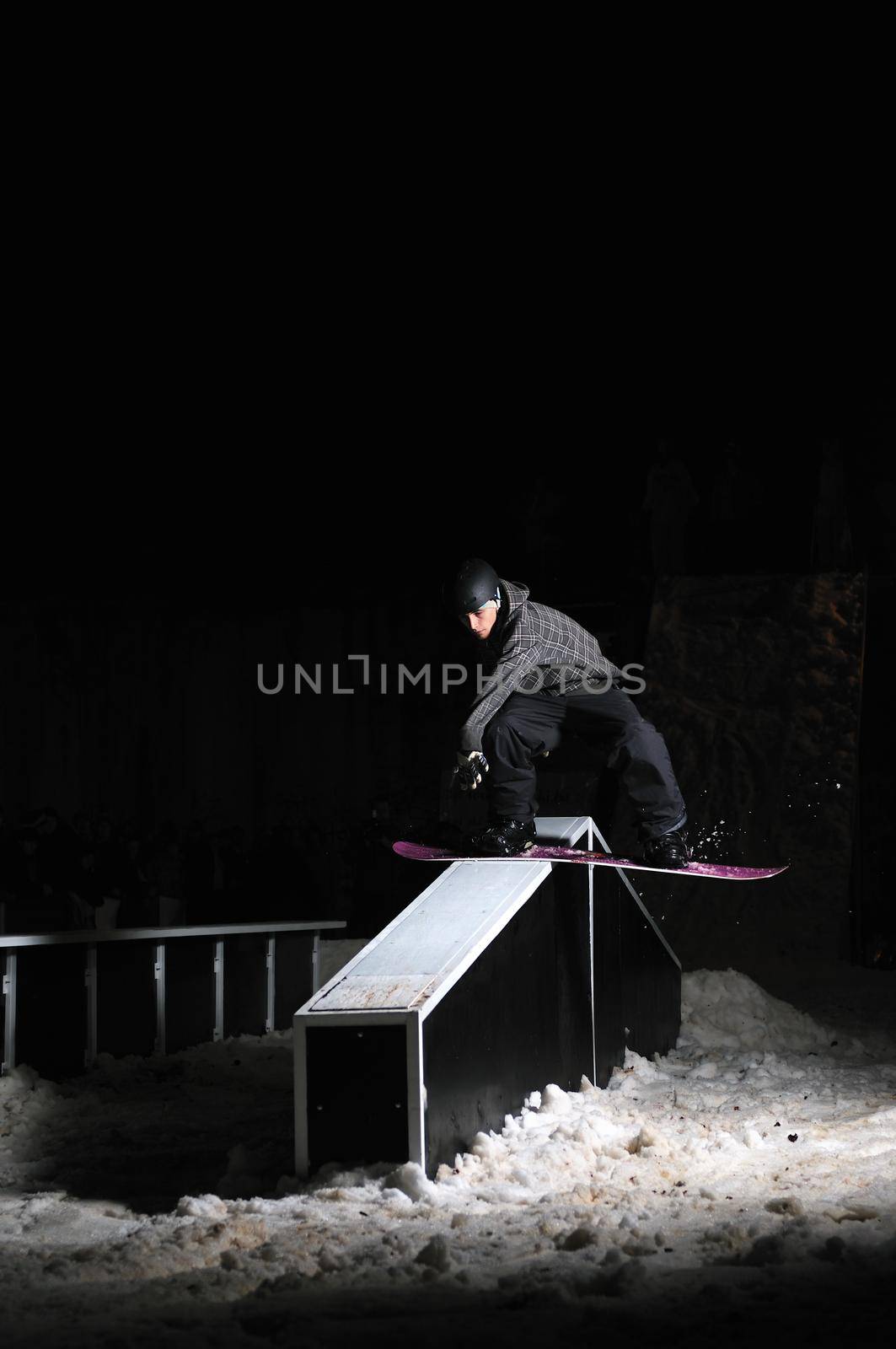 freestyle snowboarder jump in air at night by dotshock