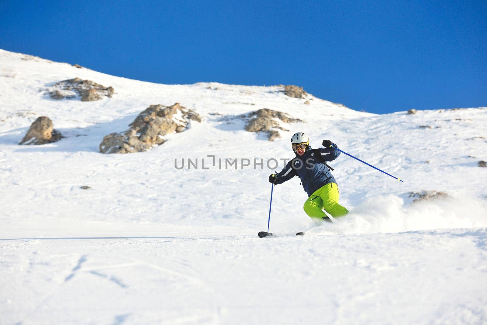 skiing on fresh snow at winter season at beautiful sunny day by dotshock