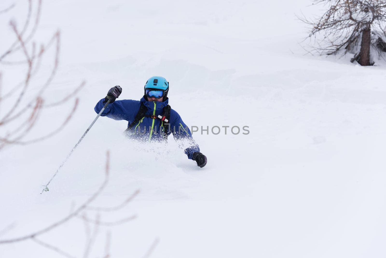 freeride skier skiing in deep powder snow by dotshock