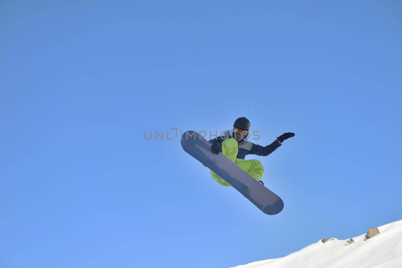 jumping freestyle skier at mountain with fresh snow fresh sunny winter day