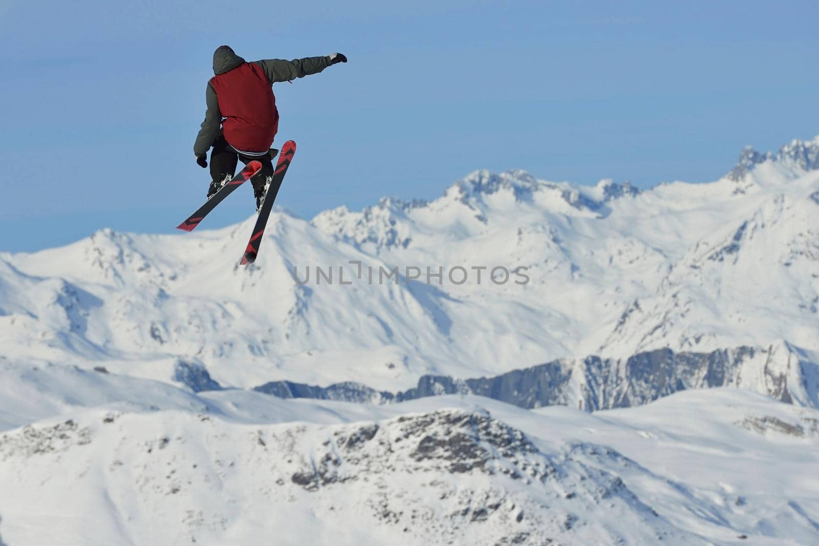 jumping skier at mountain winter snow fresh suny day