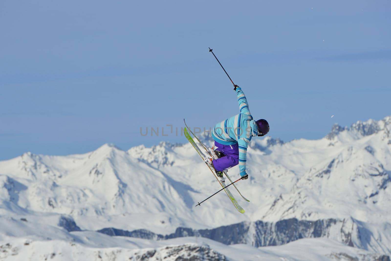 jumping skier at mountain winter snow fresh suny day