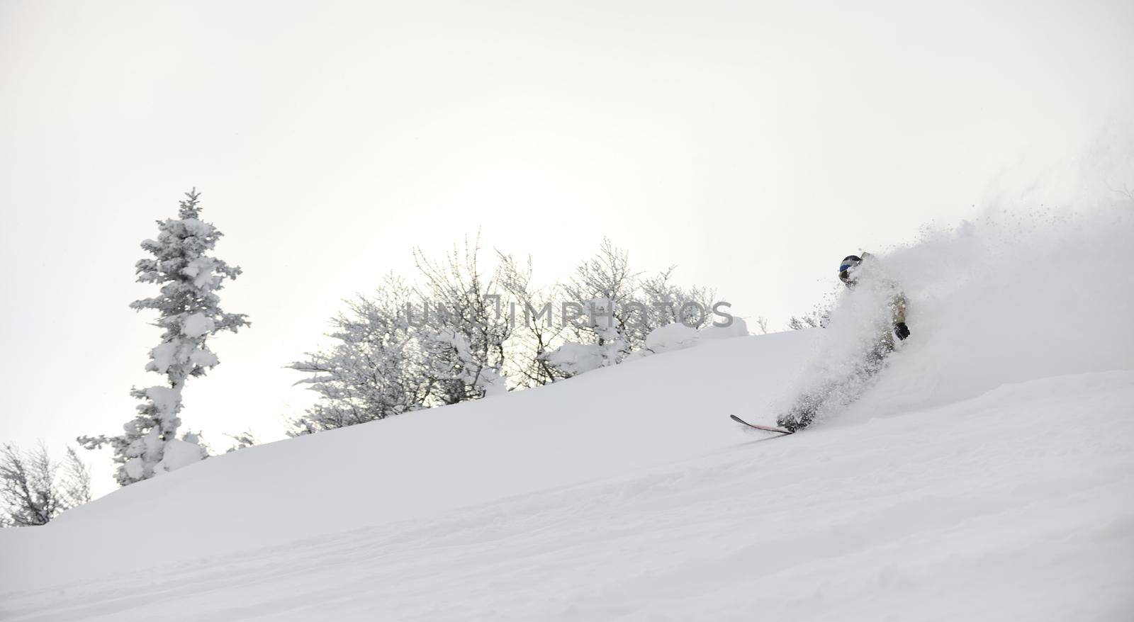 freestyle snowboarder jump and ride free style  at sunny winter day on mountain