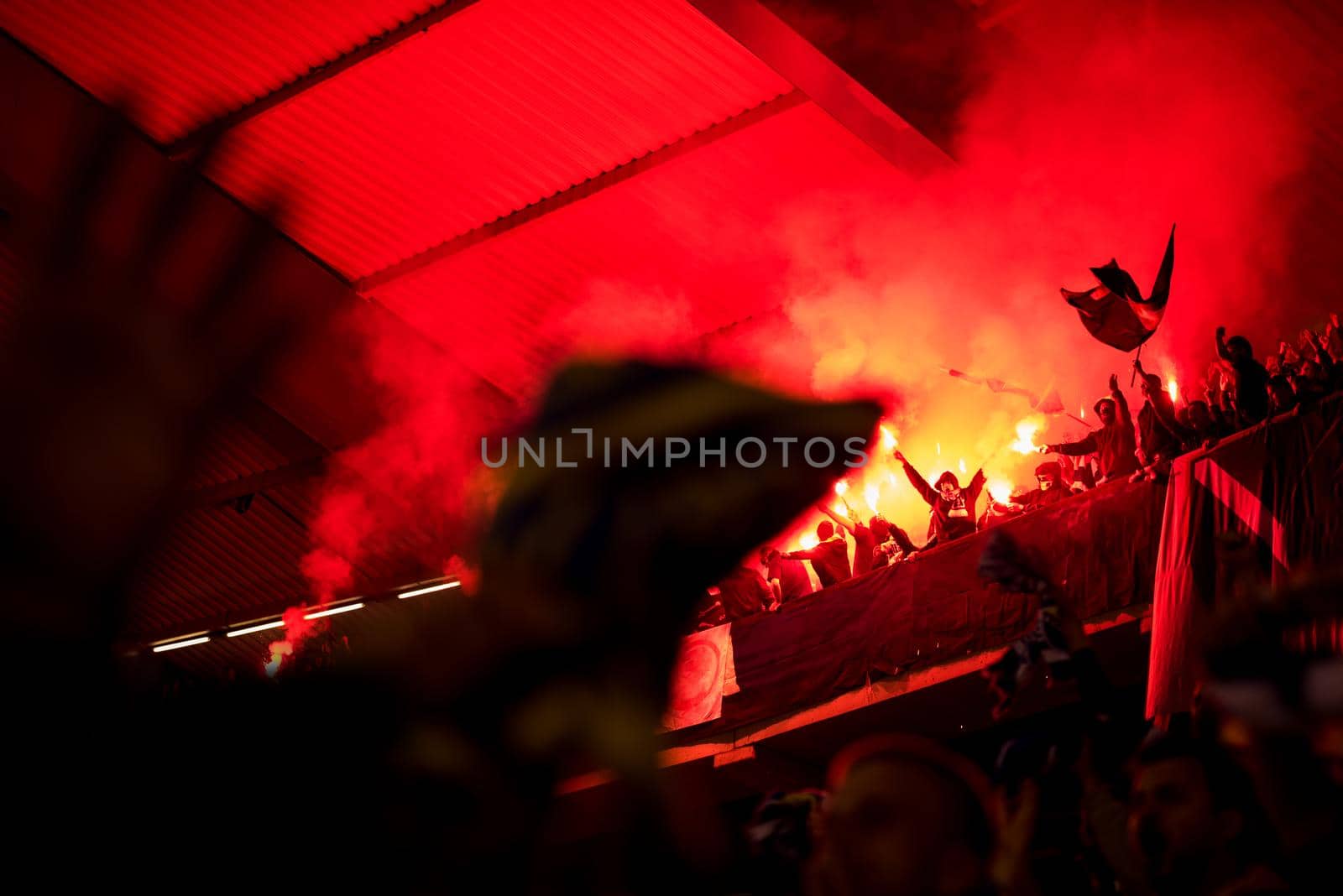 football hooligans with mask holding torches in fire by dotshock