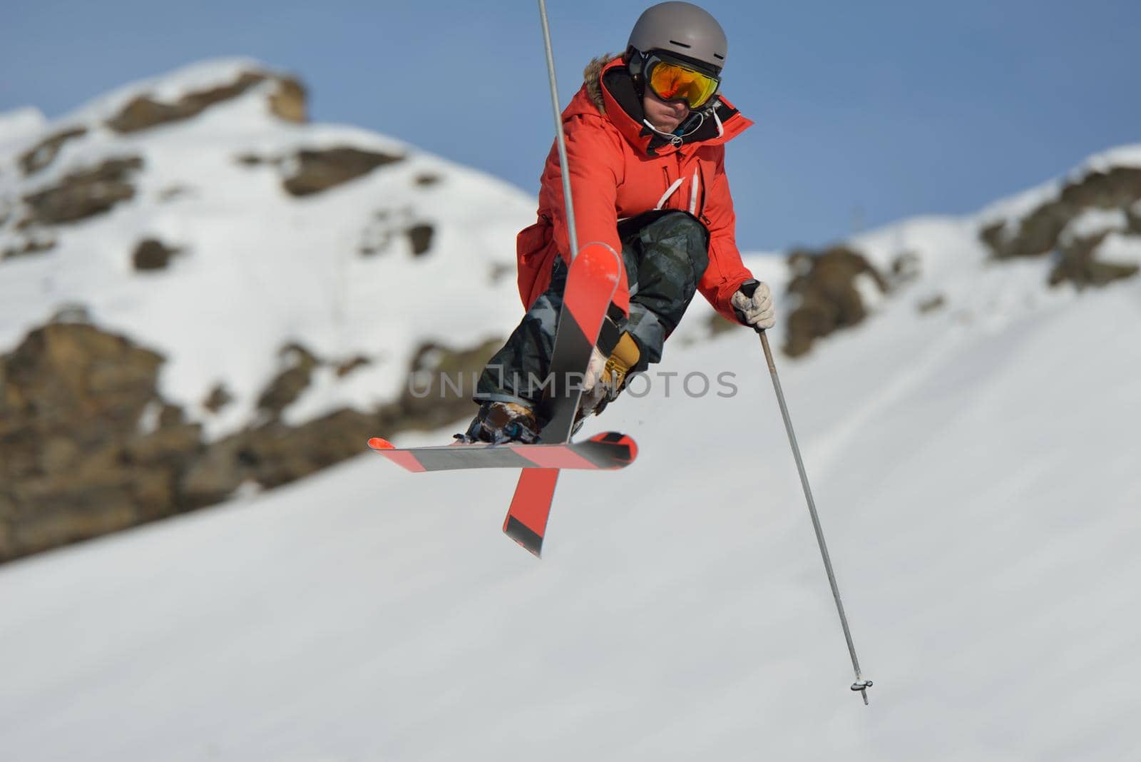 jumping skier at mountain winter snow fresh suny day