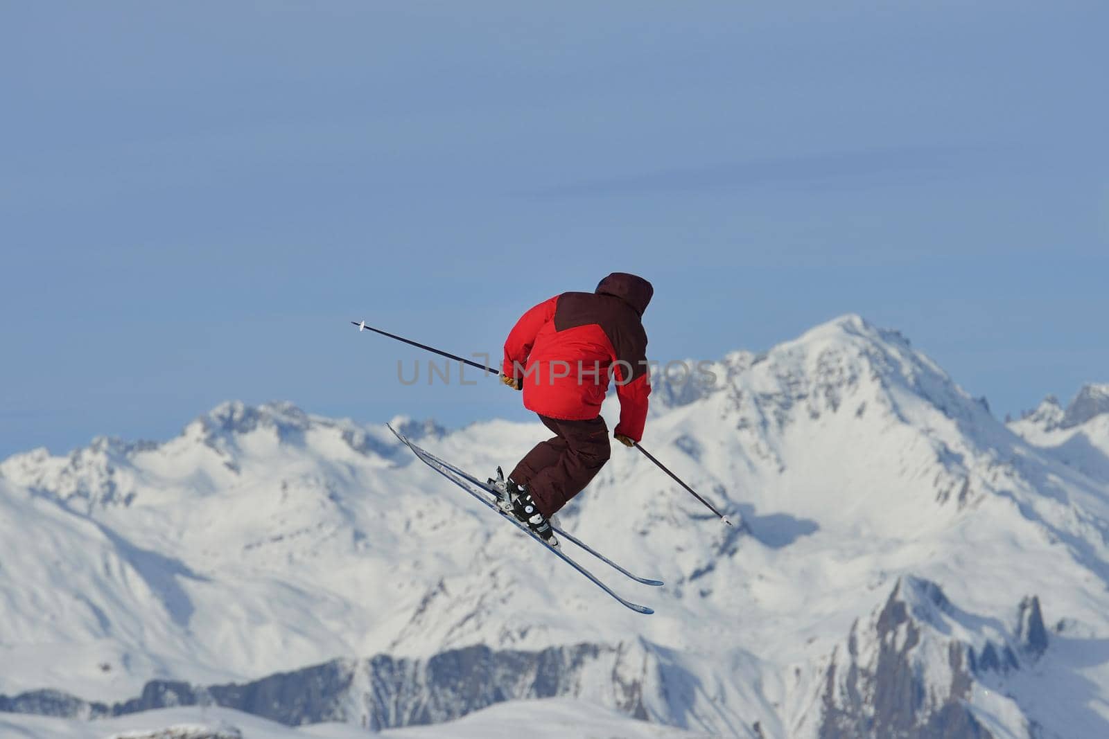 jumping skier at mountain winter snow fresh suny day