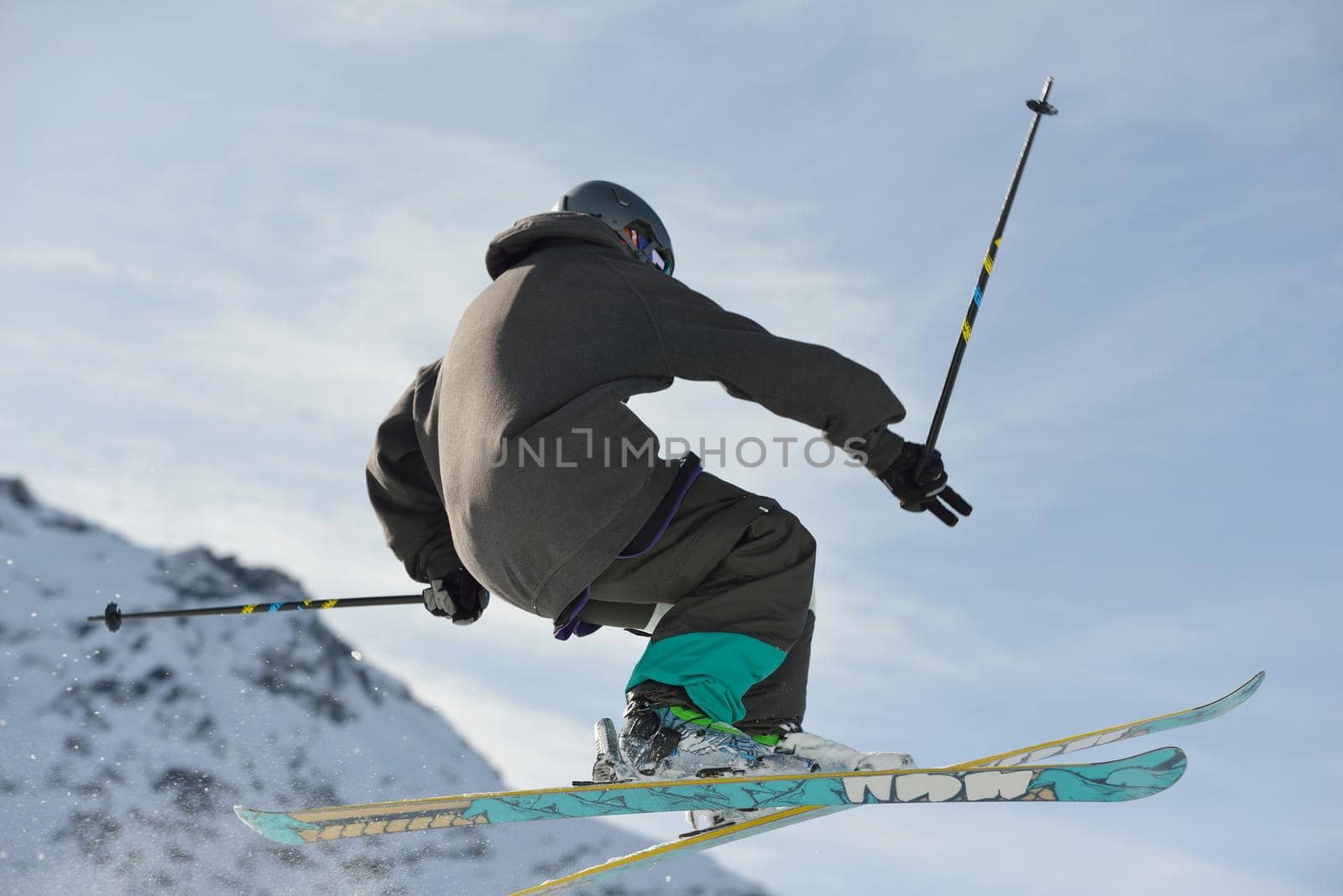 jumping skier at mountain winter snow fresh suny day