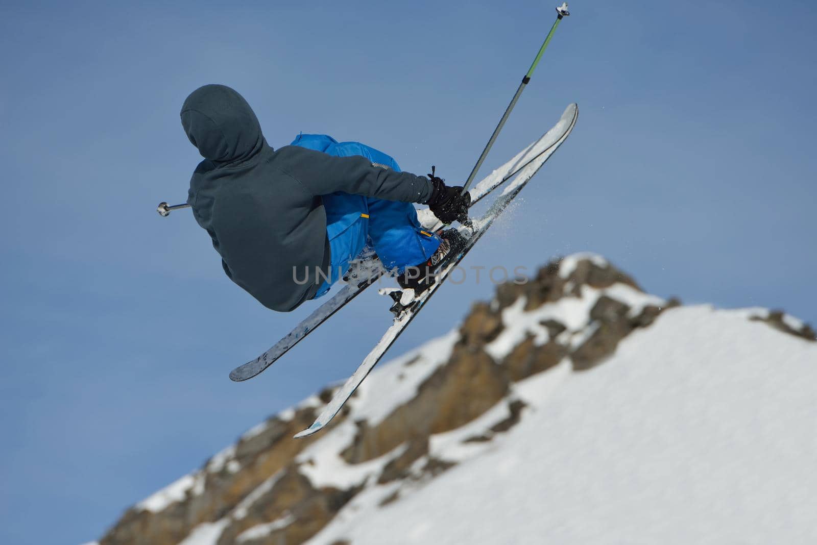 jumping skier at mountain winter snow fresh suny day