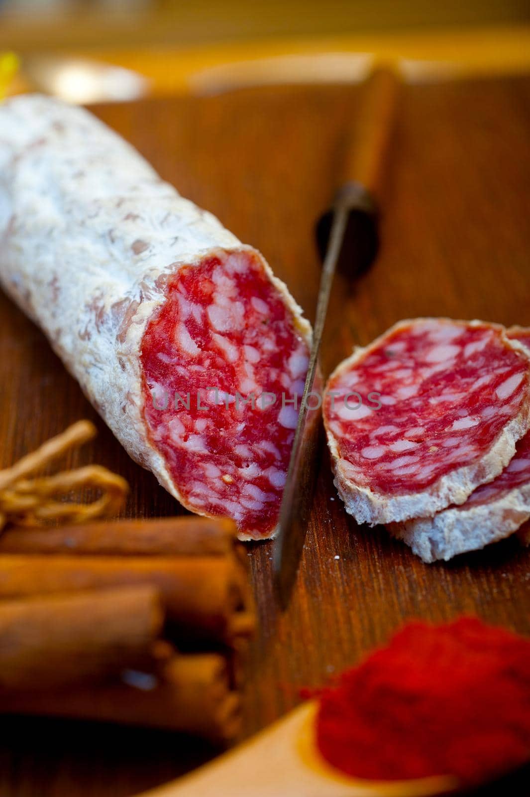 traditional Italian salame cured sausage sliced on a wood board by keko64