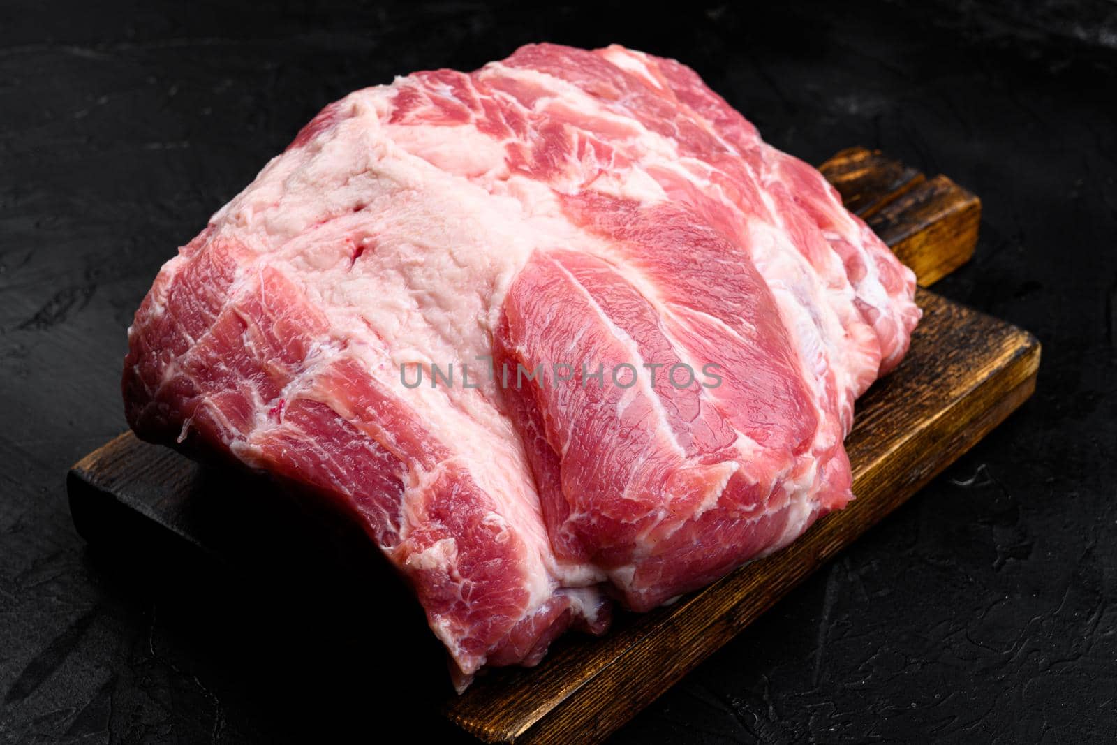 Pork shoulder fresh raw meat set, on black dark stone table background