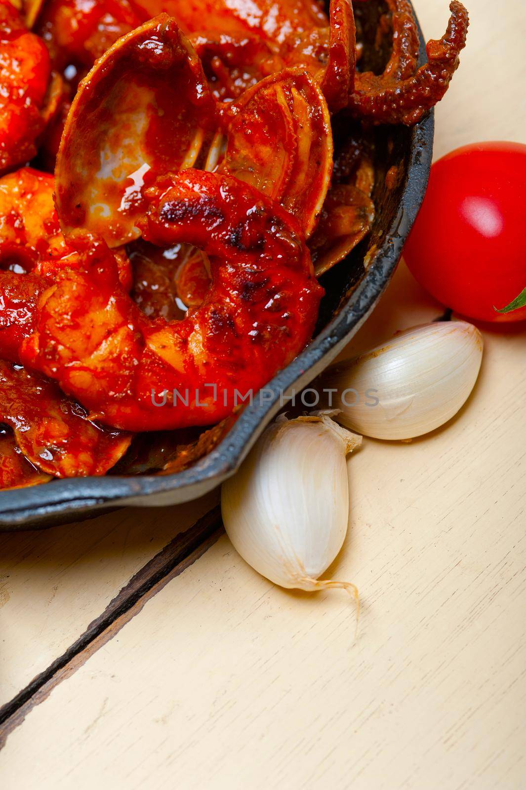fresh seafoos stew on an iron skillet by keko64
