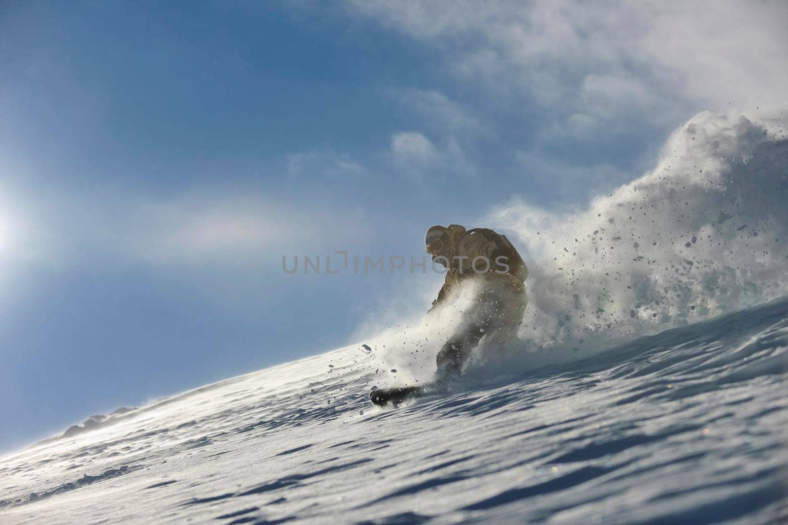 freestyle snowboarder jump and ride free style  at sunny winter day on mountain